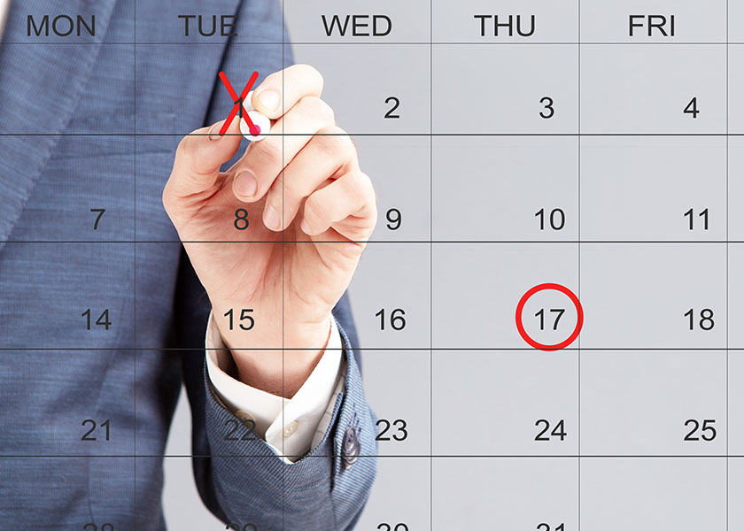 Man marking calendar